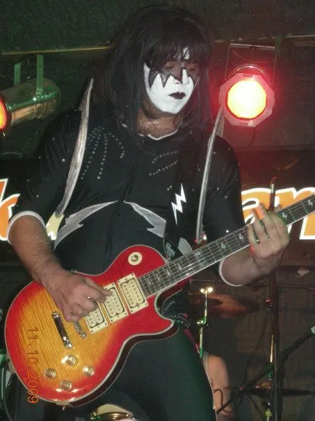 Integrante de Revenge caracterizado como Ace Frehley, tocando la guitarra en el show